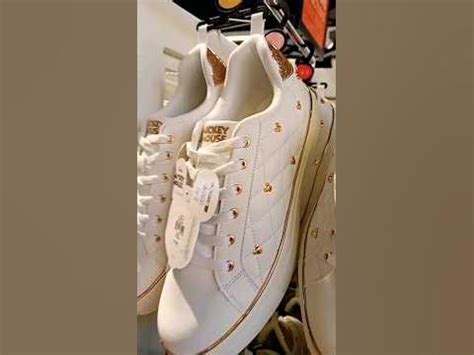 white mickey mouse studded trainers.